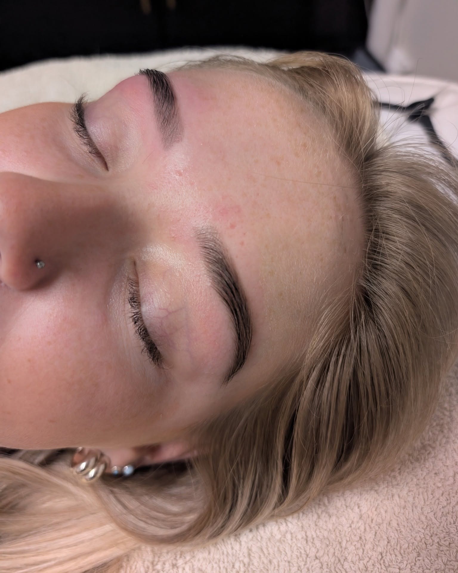 Soft natural brows on a client resting her eyes