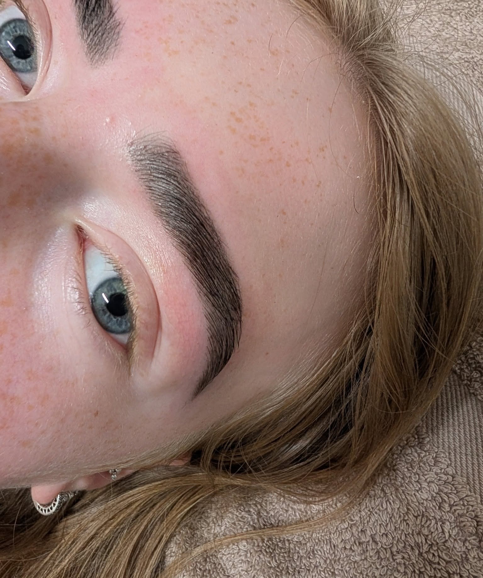 Groomed brows framing blue eyes